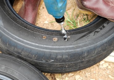 tire gardening, making concrete posts, making drainage holes in tires, uses for old tires,
